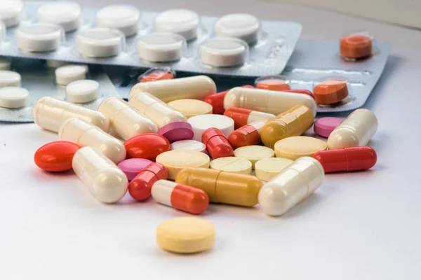 Tablet hastalıklarının tedavisi için bir sürü bir masada evde dağılmışlardır. Masadaki diğer ilaçlar. Vitaminler bir masada evde. Hastanın ısısını ölçmek için termometre