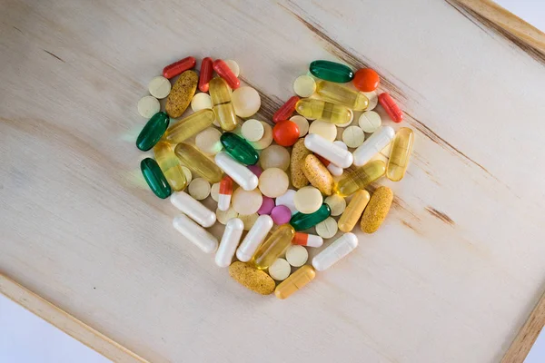 Tablet hastalıklarının tedavisi için bir sürü bir masada evde dağılmışlardır. Masadaki diğer ilaçlar. Vitaminler bir masada evde. Hastanın ısısını ölçmek için termometre