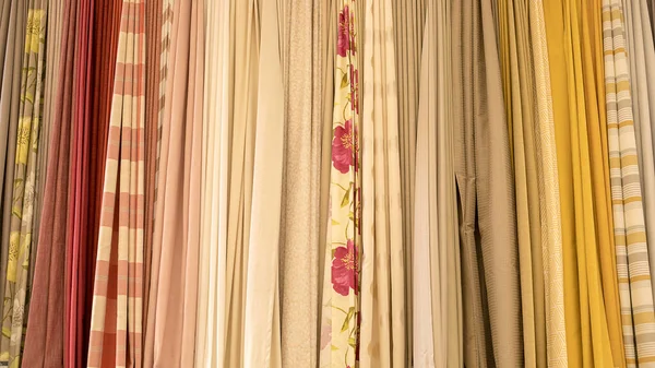 Colorful curtain samples. Fabrics in the store.