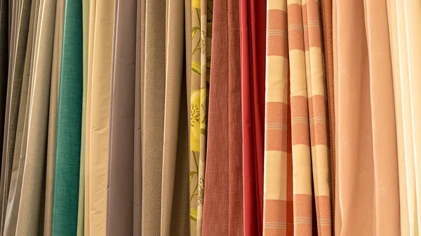 Colorful curtain samples. Fabrics in the store.