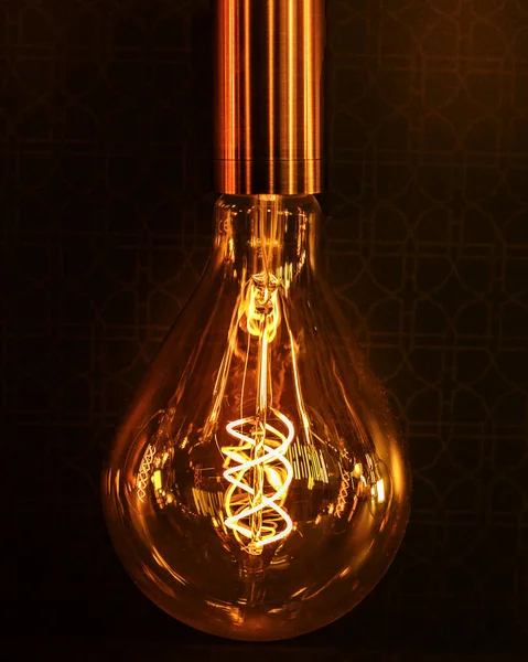 Lighting decor. Retro light bulb filament close up.Illuminated. Gold worm colors. Great idea