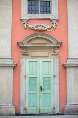 Güzel eski kapı ve pencere, yontulmuş mimari elementler, pembe ve yeşil renkler. Yakın plan fotoğraf. Avrupa