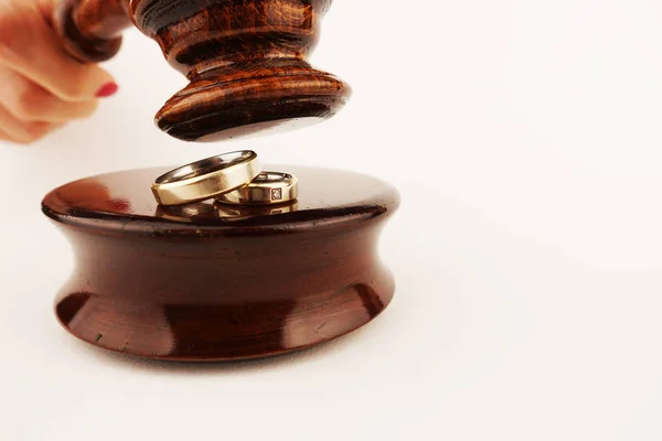 Family law concept or divorce decree with wedding rings under the judge gavel