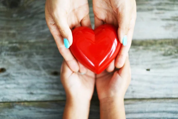 Hands Woman Giving Shiny Red Heart Her Daughter Sharing Love — Stock Photo, Image