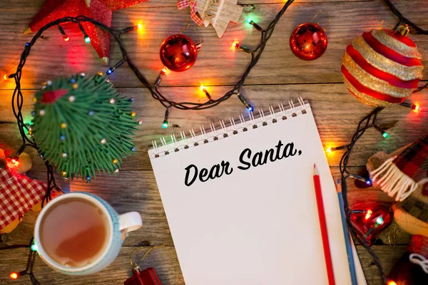 Dear Santa introduction on Santas letter, Christmas background with notebook surrounded by decorations