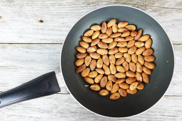 Roasted Almonds Dark Pan Rustic Wooden Background — Stock Photo, Image