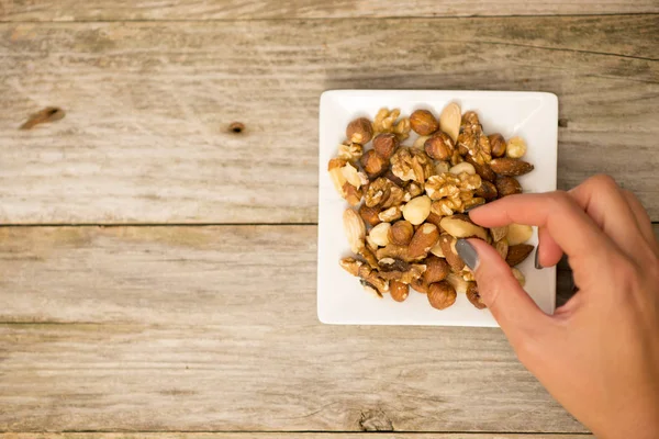 Healthy Snack Concept Womans Hand Picking Raw Mixed Nuts — Stock Photo, Image