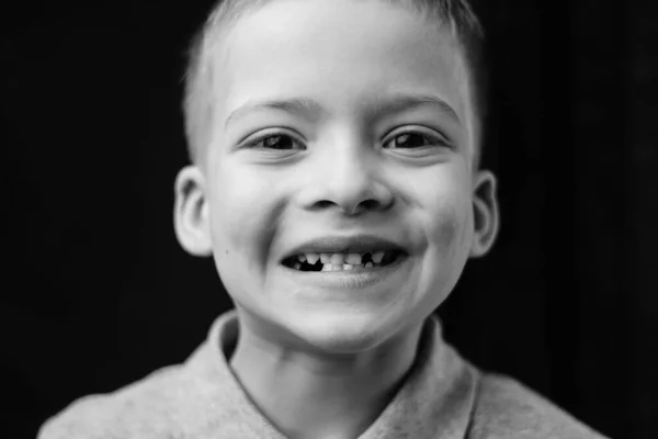 a baby tooth fell out. a preschooler shows a toothless mouth