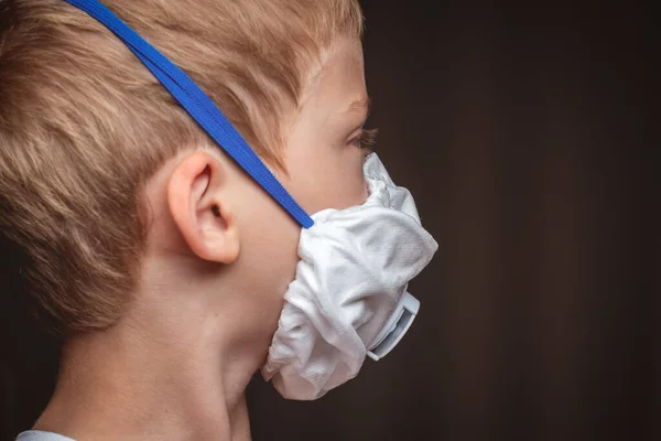 child in protective respirator with filter. protecting children from the virus