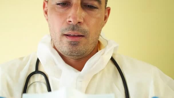 Tired Male Doctor Removes Medical Mask Wipes Sweat Forehead Hand — Stock Video