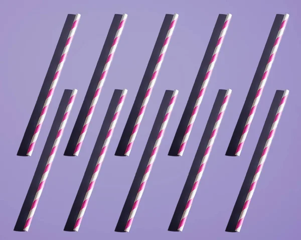 Tubes for drinks on a solid background. Pop art concept. Hard shadow. Party preparation.