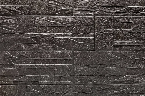 Black decorative stone tile texture with abstract patterns, grunge background