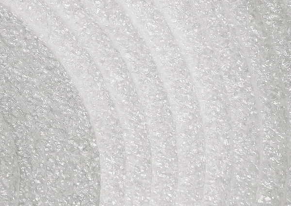 The texture of white industrial foam in a roll close-up, building, insulation material background