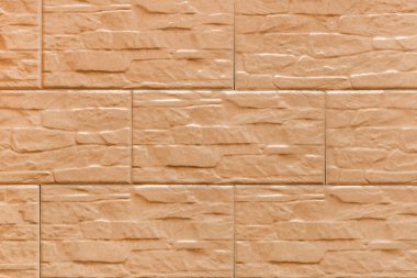 Bej rengi soyut taş blokların dokusu, dekoratif tuğla duvar arkaplanı