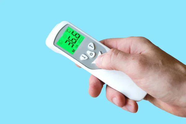 Hand Holding Contactless Thermometer Showing Temperature Degrees Celsius Blue Background — Stock Photo, Image