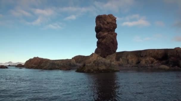 Stone rocks cliffs in water on background of Arctic Ocean in Svalbard. — Stock Video