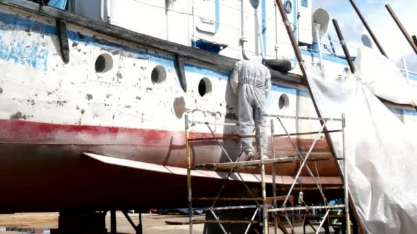 在造船厂的修理过程中，工人们把油漆撕碎在金属上. — 图库视频影像