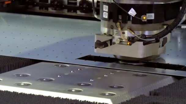 Cutting holes perforation stamping of metal sheets on industrial CNC machine. — Stock Video