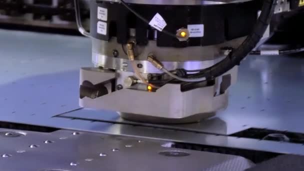 Cutting holes perforation stamping of metal sheets on industrial CNC machine. — Stock Video