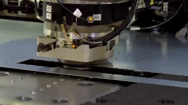 Cutting holes perforation stamping of metal sheets on industrial CNC machine. — Stock Video