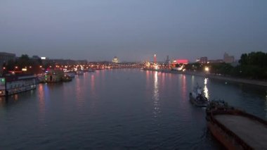 Zaman atlamalı akşam nehir boyunca yüzen tekne.