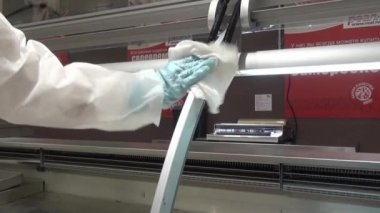 İşçinin el buzdolabı bir süpermarkette temizler.