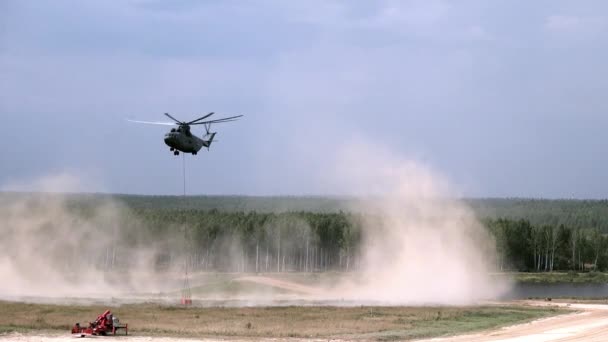 Helicóptero de incêndio de carga com concha suspensa leva água do reservatório . — Vídeo de Stock