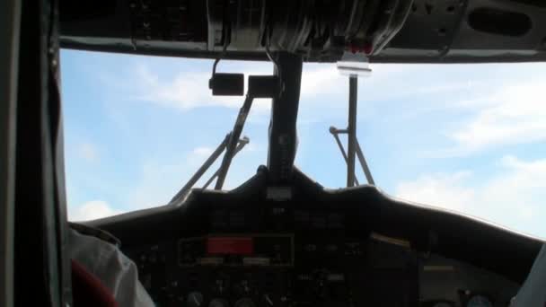 View from the back on two pilots in the plane cockpit on background of window. — Stock Video