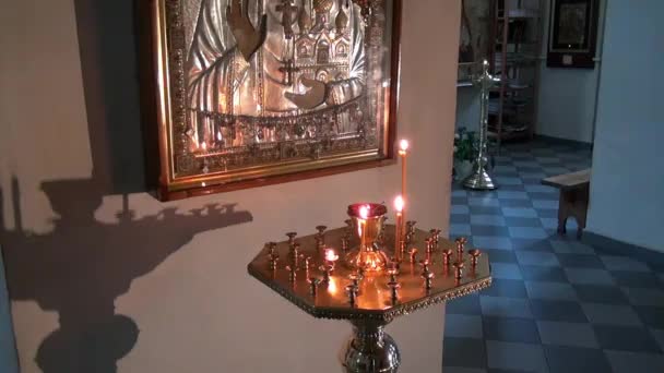 Candles burn before icon of Saint Elizabeth in monastery of New Martyrs. — Stock Video