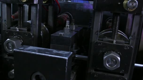 Close-up of metal-rolling machines for production metal steel pipes in factory. — Stock Video