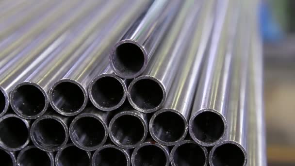 Stainless steel pipes lie at the factory. — Stock Video