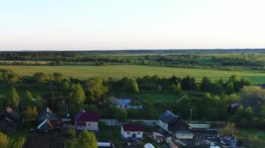 Nehrin üzerinde evleri ve bahçeleri olan, çarpıcı manzaralı yeşil otlaklarla çevrili bir köy manzarası. Açık hava iklimi kavramı.