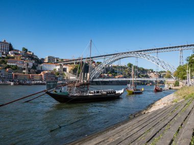 Porto, Portekiz 'de nehir kıyısındaki Rabelo tekneleri, arka planda Dom Luis I köprüsü..