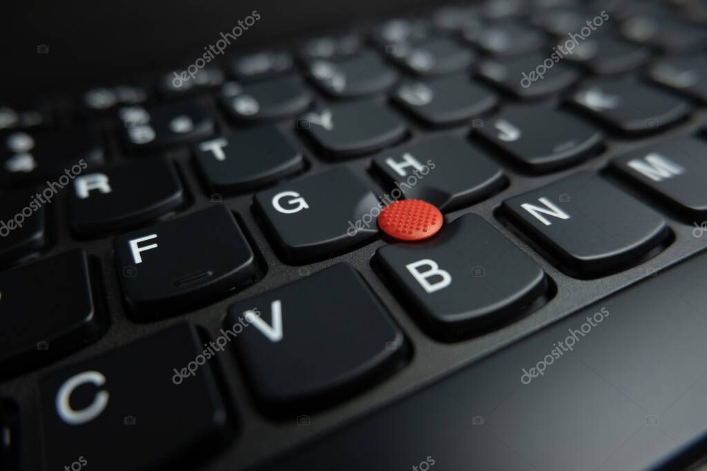Close up of trackpoint pointing device on Lenovo Thinkpad notebook computer. Shallow depth of field.