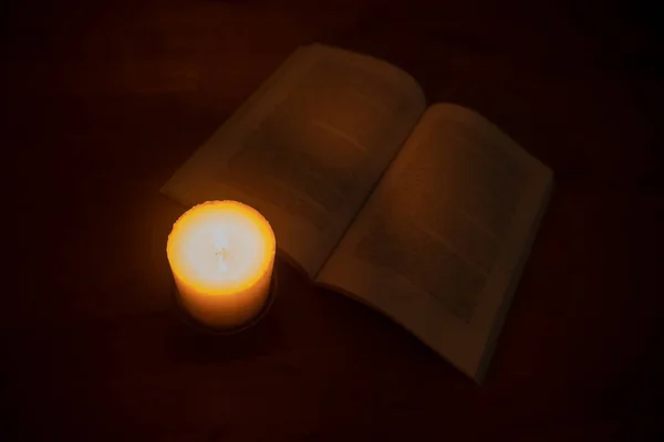 Candle Burning Brightly Open Book Wooden Table Top View — Stock Photo, Image