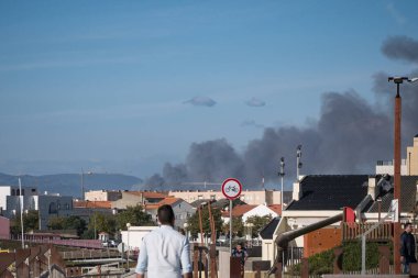Yazın sonlarında çıkan orman yangınında Portekiz 'deki evlerin arkasında kara duman bulutları yükseliyor..