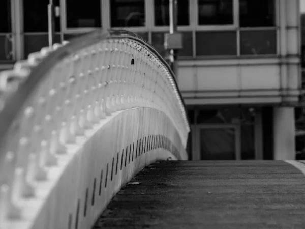 Black and white image of a love lock attached to railings on Bridge over River Liffey in Dublin, Ireland.