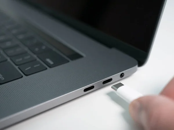 灰色のラップトップ ノートブックコンピュータのポートに白いUsb Type CまたはThunderbolt 3ケーブルを差し込む手 — ストック写真