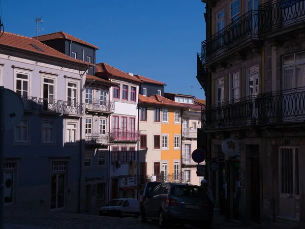 伝統的な バルコニーで衣類乾燥や花とポルトポルトガルの典型的なポルトガルの家 影が見えない通りの片側 青空と晴れた日 — ストック写真