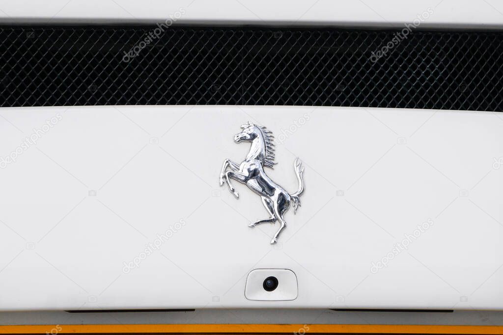 Prancing Horse Ferrari logo on the back on a luxury white Ferrari car