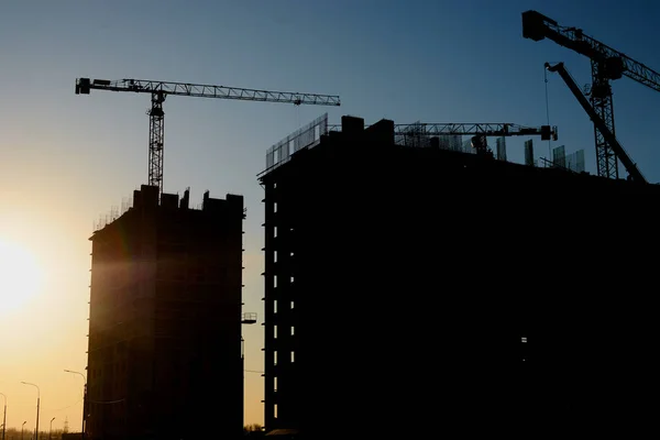 construction of the building cranes in the strongest light, otherwise