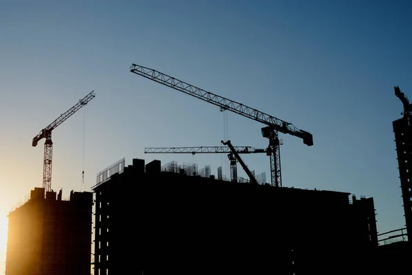 construction of the building cranes in the strongest light, otherwise