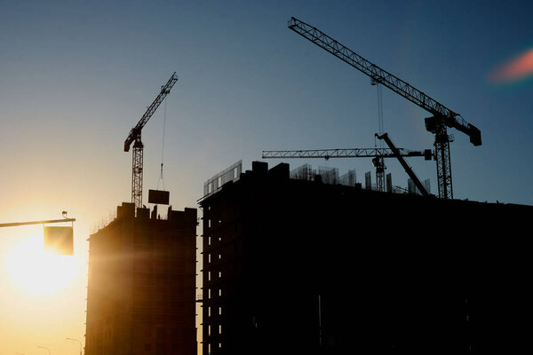 construction of the building cranes in the strongest light, otherwise