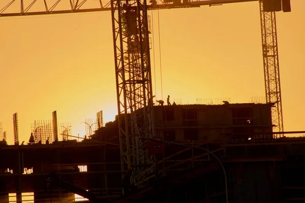 construction of the building cranes in the strongest light, otherwise