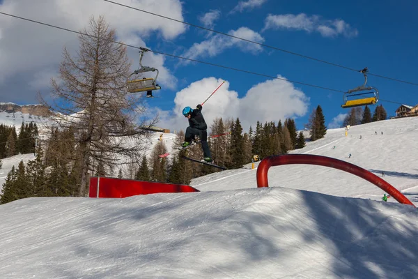 Skier in Action: Ski Jumping in the Mountain Snowpark.