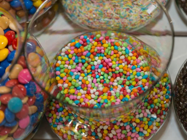 Colorful Confetti Candy inside Transparent Glass Container.