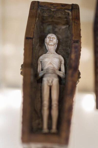 Small Statuette depicting a Corpse inside a Wooden Coffin
