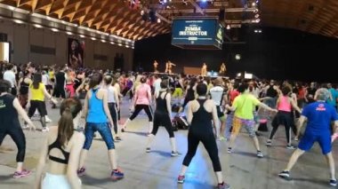 Rimini, İtalya - Haziran 2019: Spor Salonunda Fitness Egzersiz - Sahnede Müzik ve Öğretmen ile Kamu Etkinliği sırasında Zumba Egzersizleri yapan insanlar