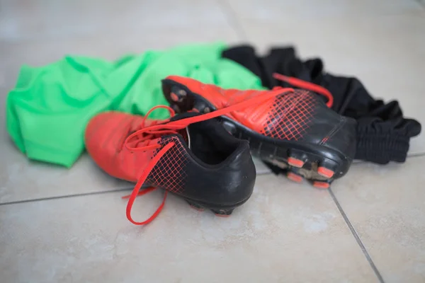 Red Soccer Shoes and Dirty Clothing and Bibs for Soccer — Stock Photo, Image