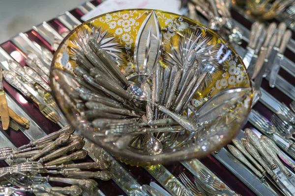 Silver Spoons in a Decorated Glass Container: Silverware — Stock Photo, Image